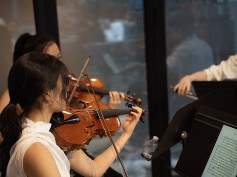 Two young violinists playing at a concert in Los Angeles